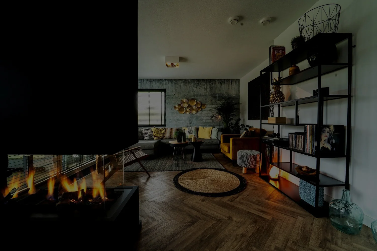 Modern living room with fireplace, sofa, and decorative shelving